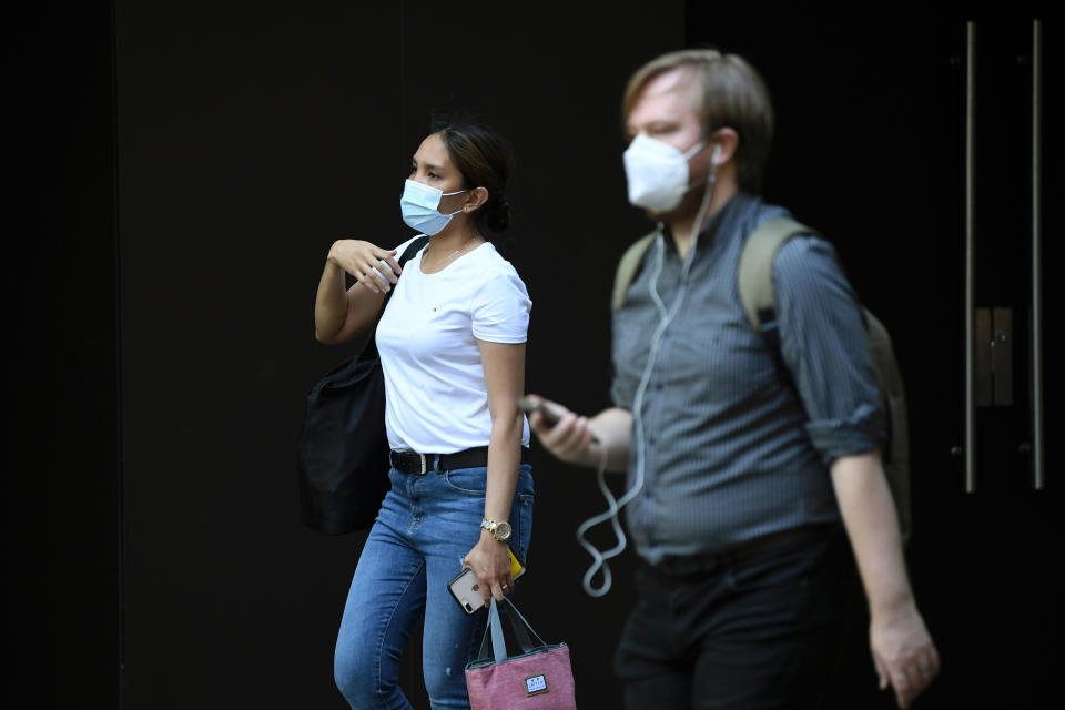 Pedestrians wearing a face mask in Sydney. Source: AAP