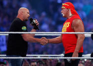 "Stone Cold" Steve Austin, left, and Hulk Hogan shake hands during Wrestlemania XXX at the Mercedes-Benz Super Dome in New Orleans on Sunday, April 6, 2014. (Jonathan Bachman/AP Images for WWE)