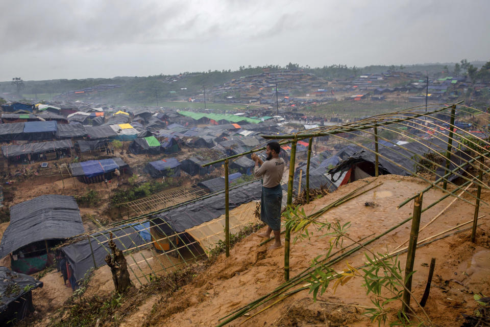 -FILE- In this Wednesday, Sept. 20, 2017, file photo A Rohingya Muslim man, who crossed over from Myanmar into Bangladesh, builds a shelter for his family in Taiy Khali refugee camp, Bangladesh. Gambia has filed a case at the United Nations' highest court in The Hague, Netherlands, Monday, Nov. 11, 2019, accusing Myanmar of genocide in its campaign against the Rohingya Muslim minority. A statement released Monday by lawyers for Gambia says the case also asks the International Court of Justice to order measures "to stop Myanmar's genocidal conduct immediately." (AP Photo/Dar Yasin, file)