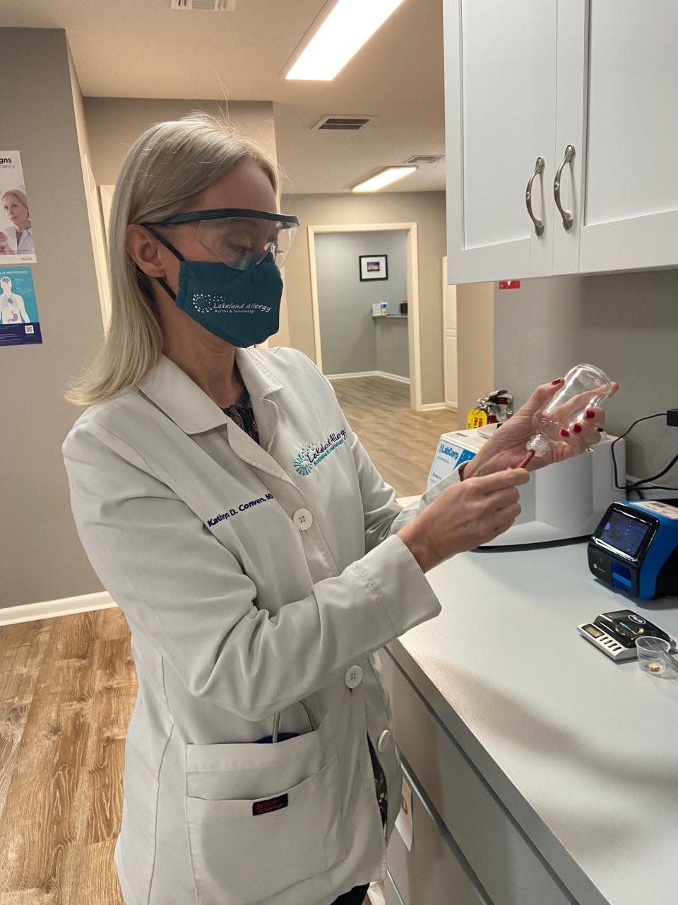 Dr. Kathryn Convers, a Lakeland allergy specialist who provides oral immunotherapy for severe food allergies, demonstrates how she would use a clinic-prepared solution in starting to desensitize patients to foods to which they are allergic.