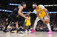 Los Angeles Lakers forward Anthony Davis (3) sets a play against Denver Nuggets forward Aaron Gordon (50) during the second half in Game 2 of an NBA basketball first-round playoff series Monday, April 22, 2024, in Denver. (AP Photo/Jack Dempsey)