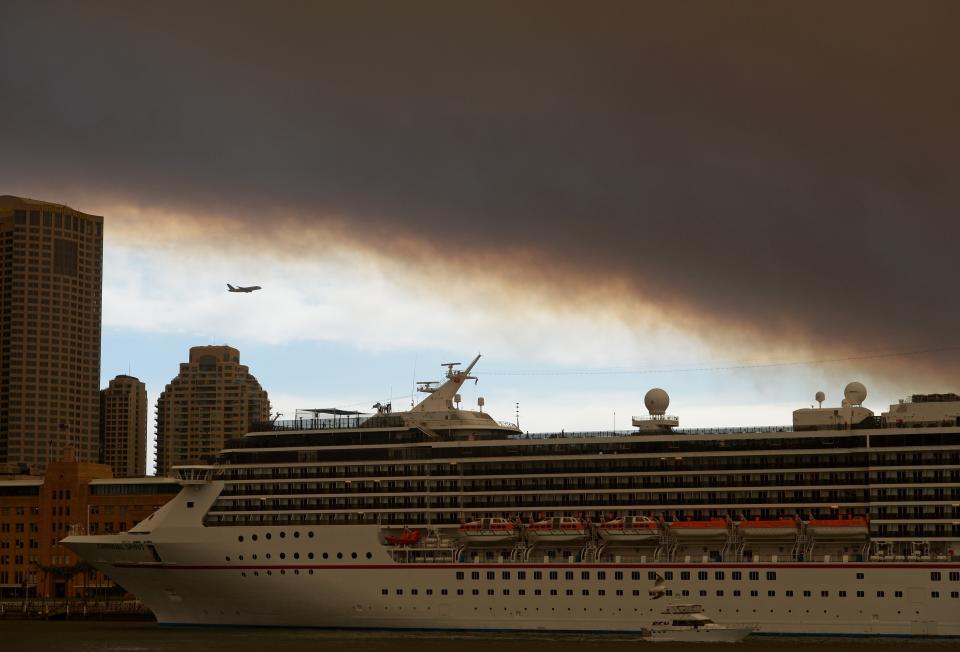 Smoke and ash from wildfires burning across the state of New South Wales blankets a cruise ship in Sydney Harbour on October 17, 2013. (GREG WOOD/AFP/Getty Images)