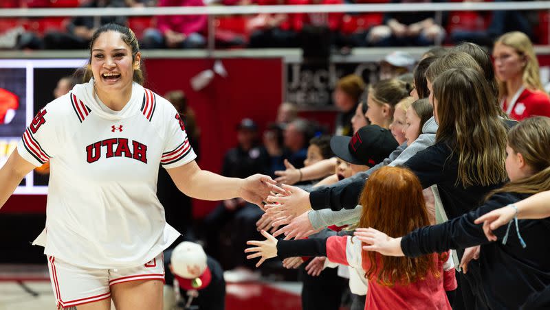 Utah Utes forward Alissa Pili (35) high-fives fans before the women’s college basketball game between the Utah Utes and the Oregon State Beavers at the Jon M. Huntsman Center in Salt Lake City on Friday, Feb. 9, 2024.