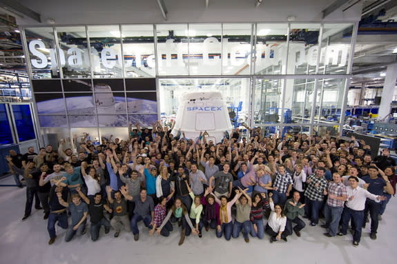 Workers cheers as a Dragon capsule leaves SpaceX headquarters on Feb. 23, 2015.