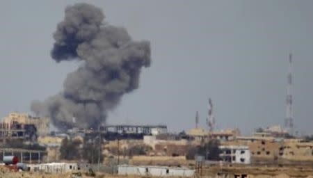 A plume of smoke rises above a building during an air strike in Tikrit March 27, 2015. U.S. and coalition forces conducted 10 air strikes against Islamic State fighters in Iraq during a 24-hour period, while U.S. forces led six air strikes in Syria, the U.S. military said on Friday. Three of the strikes in Iraq were near Tikrit, destroying vehicles and a potential car bomb. REUTERS/Thaier Al-Sudani