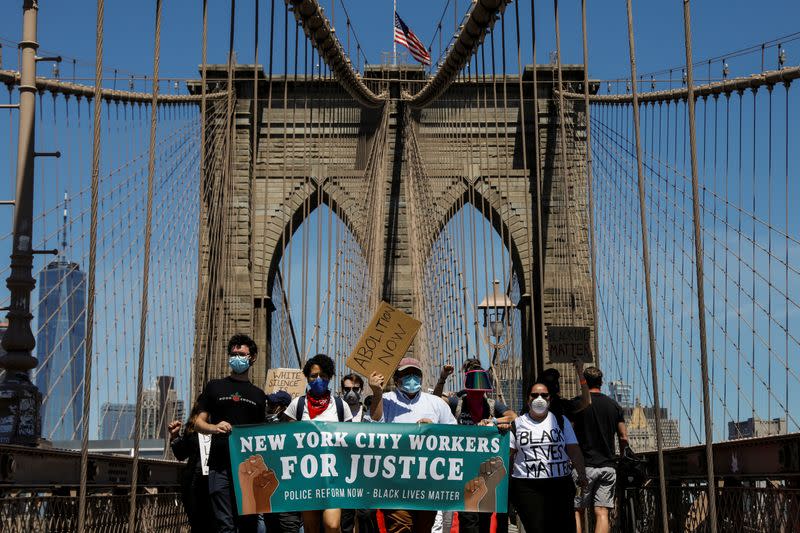 Current and former New York City Mayor's staff march across the Brooklyn Bridge to call for reforms during a protest against racial inequality in the aftermath of the death in Minneapolis police custody of George Floyd, in New York