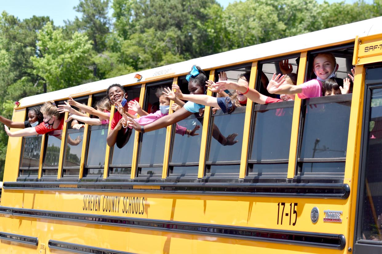 Happy Screven County Elementary School students wave bye to their teachers as the buses exit the parking lot on May 28 on the last day of the 2020-21 school year. School is back in session as of Aug. 1.
