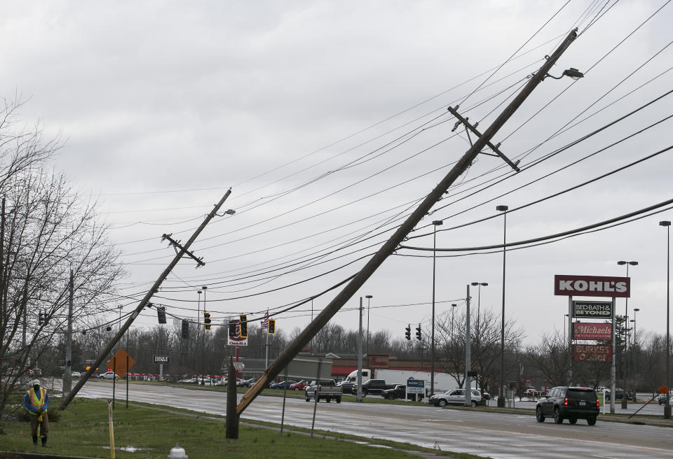 Power lines are down in Paducah, Ky. on Thursday, March 14, 2019. This Thursday, March 14, 2019 photo shows damage to the Wilbert Vault Co., in West Paducah, Ky. A tornado left a path in western Kentucky from Lovelaceville through the West Paducah area, according to Keith Todd, a spokesman for the Kentucky Transportation Cabinet. He said the public was being asked to avoid the area while utility crews, area fire departments, and rescue squads worked to clear utility lines, downed trees and other debris. (Dave Thompson/The Paducah Sun via AP)