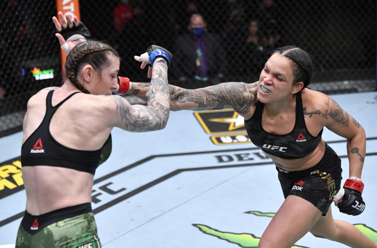 LAS VEGAS, NEVADA - MARCH 06: (R-L) Amanda Nunes of Brazil punches Megan Anderson of Australia in their UFC featherweight championship fight during the UFC 259 event at UFC APEX on March 06, 2021 in Las Vegas, Nevada. (Photo by Jeff Bottari/Zuffa LLC)