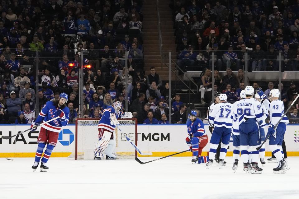 New York Rangers' Igor Shesterkin (31), Mika Zibanejad (93) and Ben Harpur (5) react as the Tampa Bay Lightning celebrate a goal by Brandon Hagel during the second period of an NHL hockey game Wednesday, April 5, 2023, in New York. (AP Photo/Frank Franklin II)