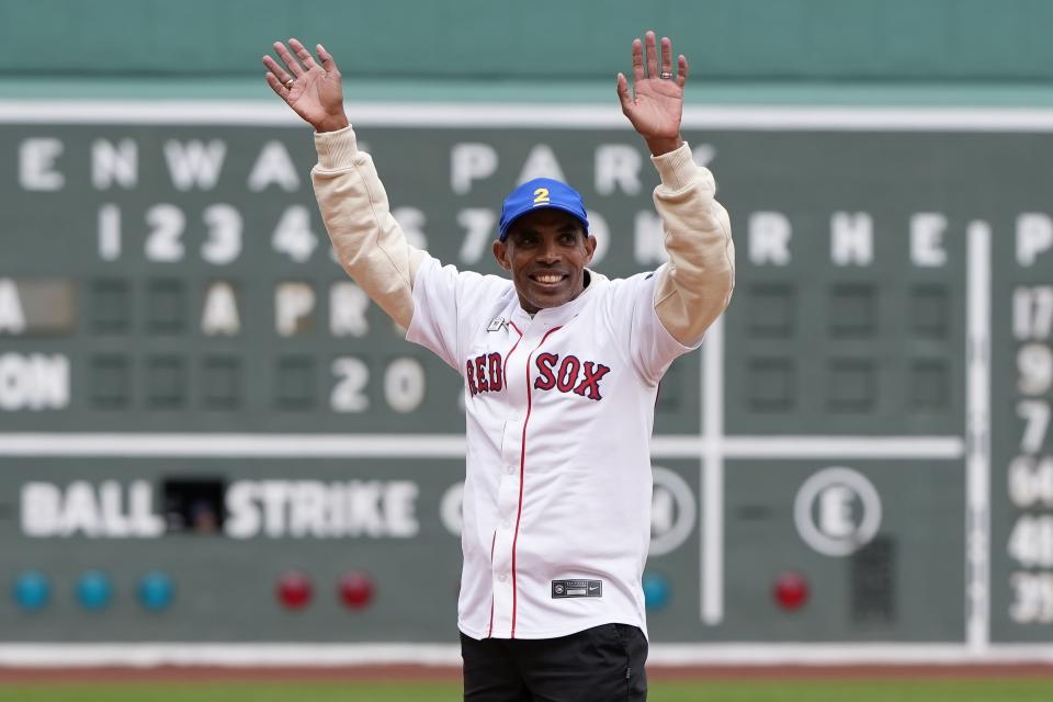 Meb Keflezighi waves to the crowd before throwing out the ceremonial first pitch before a baseball game between the Boston Red Sox and the Los Angeles Angels, Sunday, April 14, 2024, in Boston. (AP Photo/Michael Dwyer)