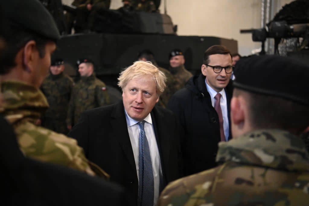 Boris Johnson speaks with British troops during a visit with Polish Prime Minister Mateusz Morawiecki to Warszawska Brygada Pancerna military base in Warsaw on February 10 (Getty Images)