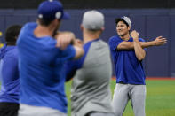 Los Angeles Dodgers' Shohei Ohtani stretches with teammates during a baseball workout at the Gocheok Sky Dome in Seoul, South Korea, Saturday, March 16, 2024. (AP Photo/Ahn Young-joon)