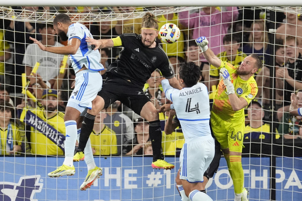 Nashville SC defender Walker Zimmerman, second from left, scores a goal past CF Montréal defender Fernando Álvarez (4) and goalkeeper Jonathan Sirois (40) during the first half of an MLS playoff soccer match Saturday, May 4, 2024, in Nashville, Tenn. (AP Photo/George Walker IV)