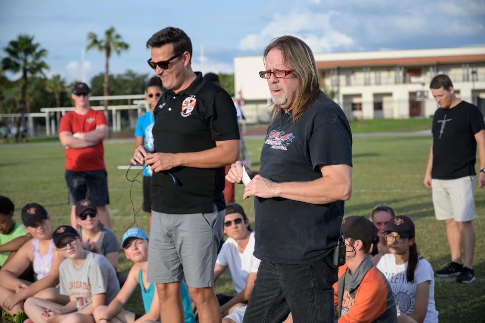 Former LHS band director Gabriel Fielder, left, stands with Anthony Wild, aka Anthony Kleppe, as he tells the Leesburg High School band students what this school means to him on Tuesday, Oct. 29, 2019.