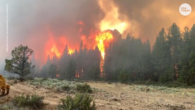 Nearly 70 active wildfires have destroyed homes and burned through about 1,562 square miles (4,047 square kilometers) &#x002014; a combined area larger than Rhode Island &#x002014; in a dozen mostly Western states, according to the National Interagency Fire Center.