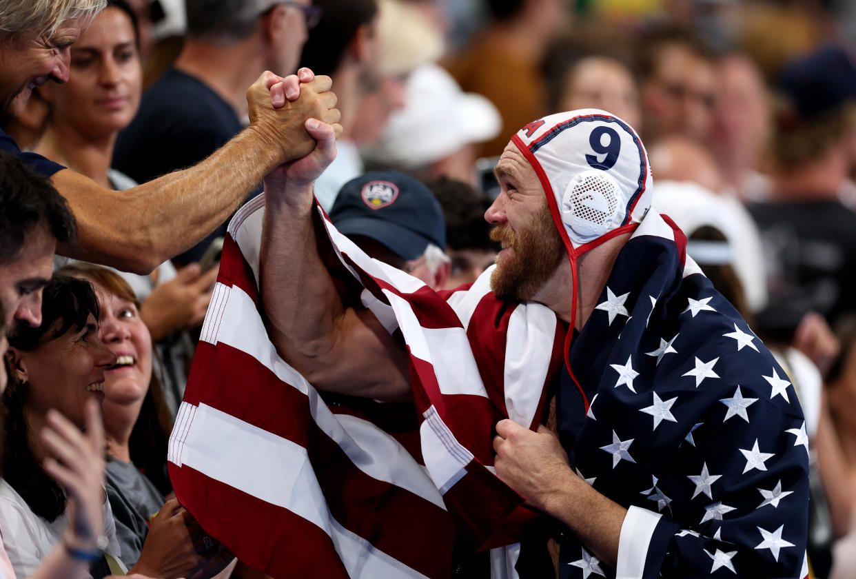 NANTERRE, FRANCE - AUGUST 11: Alex Bowen of Team United States reacts after victory whilst draped in a flag of the United States in the Bronze Medal match between Team United States and Team Hungary on day sixteen of the Olympic Games Paris 2024 at Paris La Defense Arena on August 11, 2024 in Nanterre, France. (Photo by Clive Rose/Getty Images)