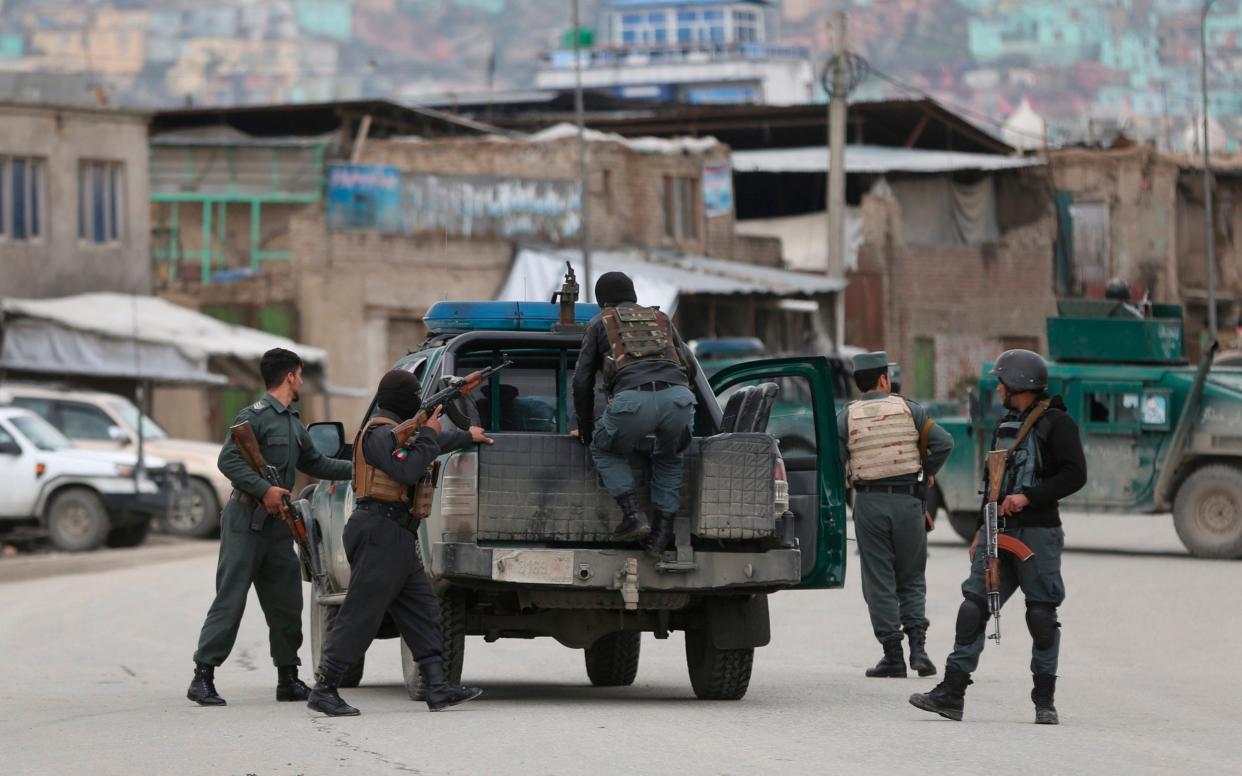 Afghan personnel arrive at the site of an attack in Kabul - AP