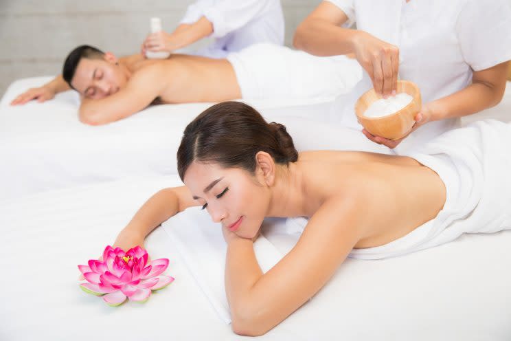 Young couple lying on the massage table and smiling, spa concept. (Photo: Getty Images)