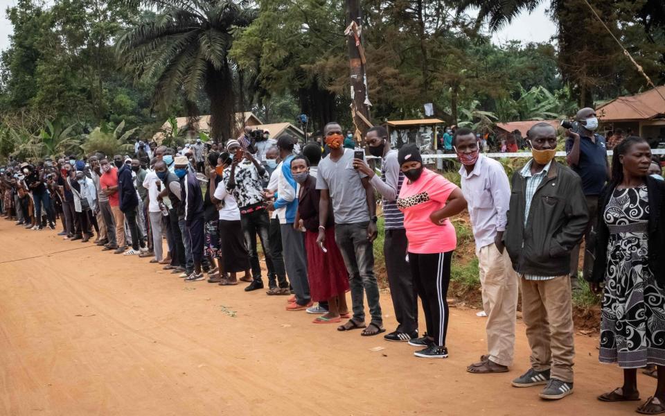 Voters wait in a line at a polling station in Magere, Uganda - Yasuyoshi Chiba/AFP