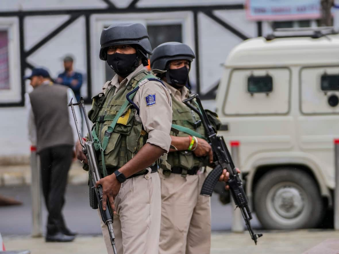 The G20 meeting in Kashmir unfolded under tight security, with Indian paramilitary soldiers keeping guard at a newly renovated market ahead of the visit of delegates. It's the first high-level international meeting in Kashmir since New Delhi stripped the Muslim-majority region of semi-autonomy in 2019. (Mukhtar Khan/AP - image credit)