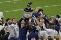 Georgia Southern coach Chad Lunsford and players hold the trophy after a victory over Louisiana Tech in the New Orleans Bowl NCAA college football game in New Orleans, Wednesday, Dec. 23, 2020. (AP Photo/Matthew Hinton)