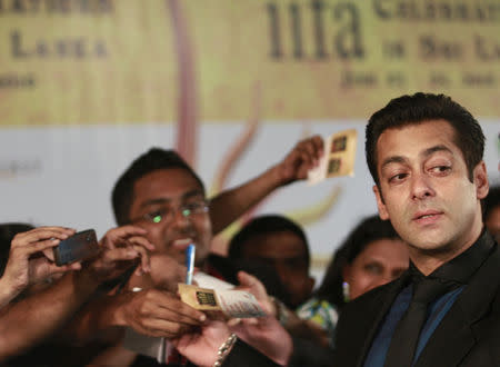 Bollywood actor Salman Khan (R) reacts on the green carpet for the International Indian Film Academy (IIFA) awards in Colombo June 5, 2010. REUTERS/Dinuka Liyanawatte