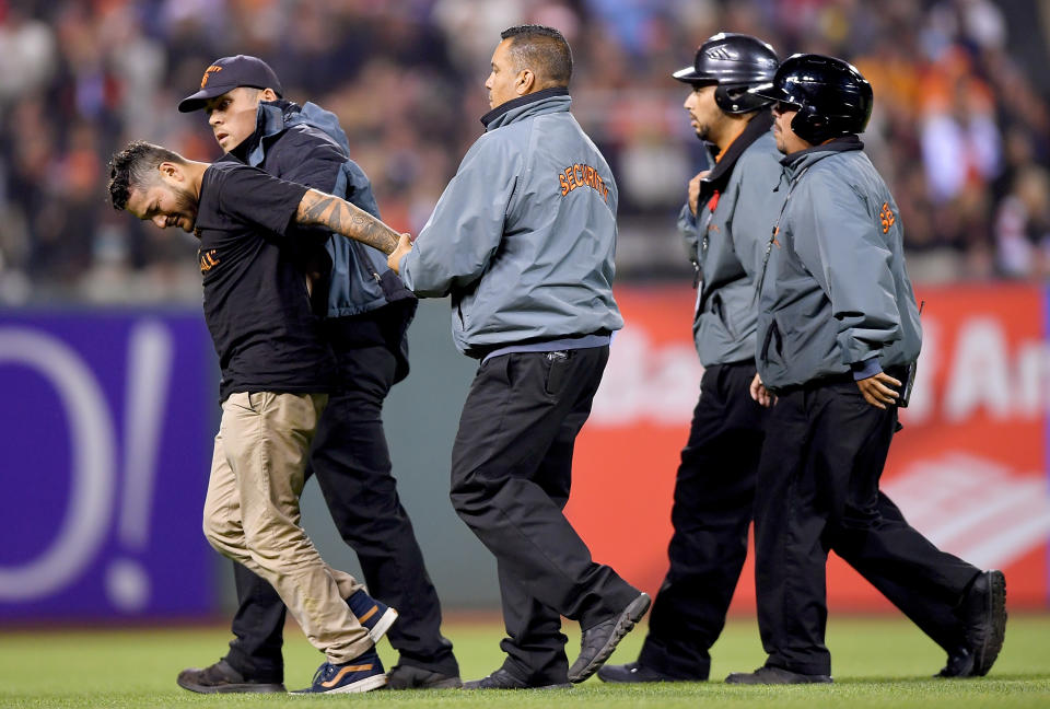 Security escorts a fan off the field after he ran onto the field interrupting the game between the Washington Nationals and San Francisco Giants in the top of the seventh inning at AT&T Park on July 29, 2016 in San Francisco, California. (Photo by Thearon W. Henderson/Getty Images)