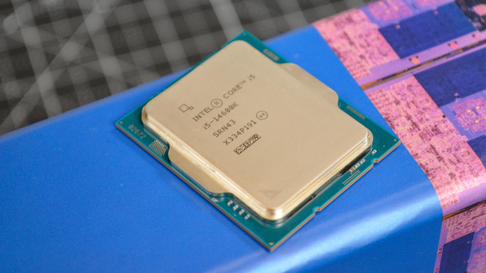 An Intel Core i5-14600K against its promotional packaging