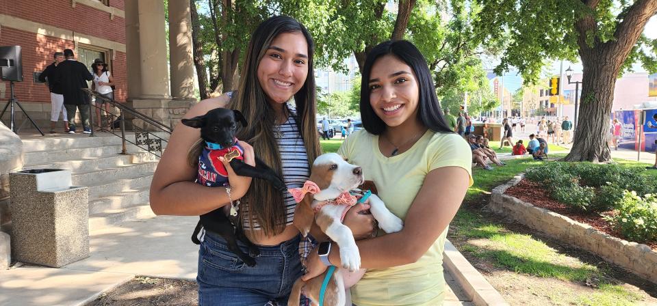 Ana and Leah Hernandez show off their pets Paco (left) and Bella (right) for the patriotic pet parade Saturday morning at the Amarillo Community Market in downtown Amarillo. Paco won the award for the waggiest tail.