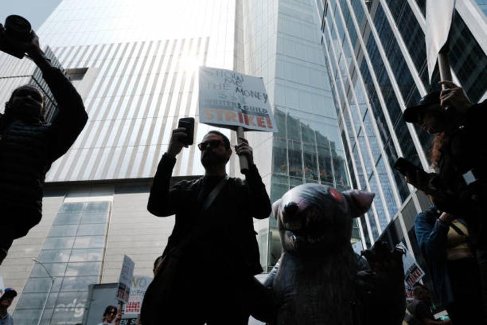 Members of the Writers Guild of America (WGA) East hold signs as they walk in the picket-line outside of HBO and Amazon’s offices on 10 May 2023 (Getty Images)