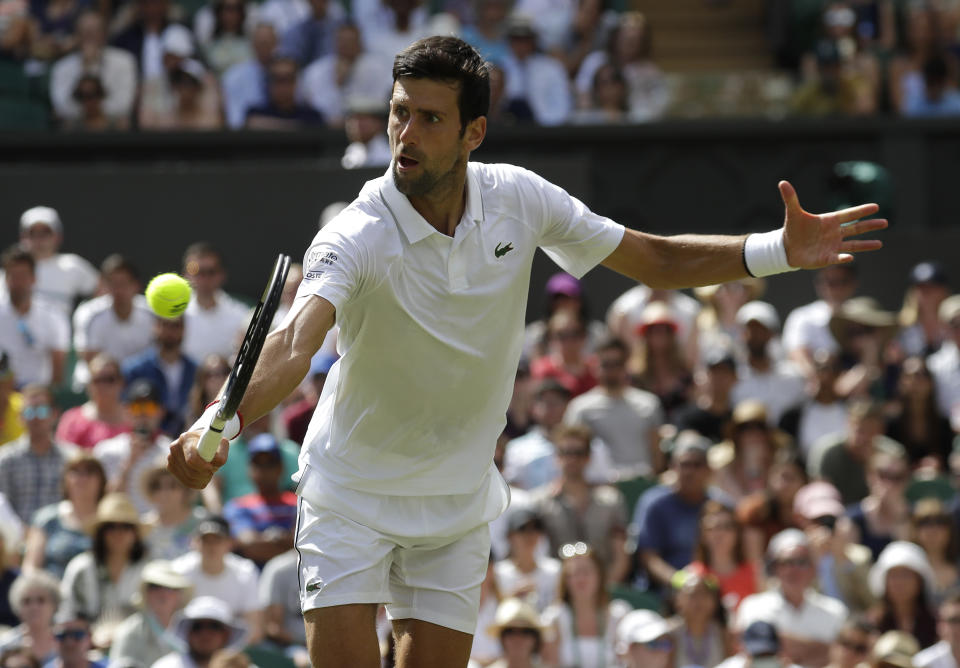 Serbia's Novak Djokovic returns to Germany's Philip Kohlschreiber in a Men's singles match during day one of the Wimbledon Tennis Championships in London, Monday, July 1, 2019. (AP Photo/Kirsty Wigglesworth)