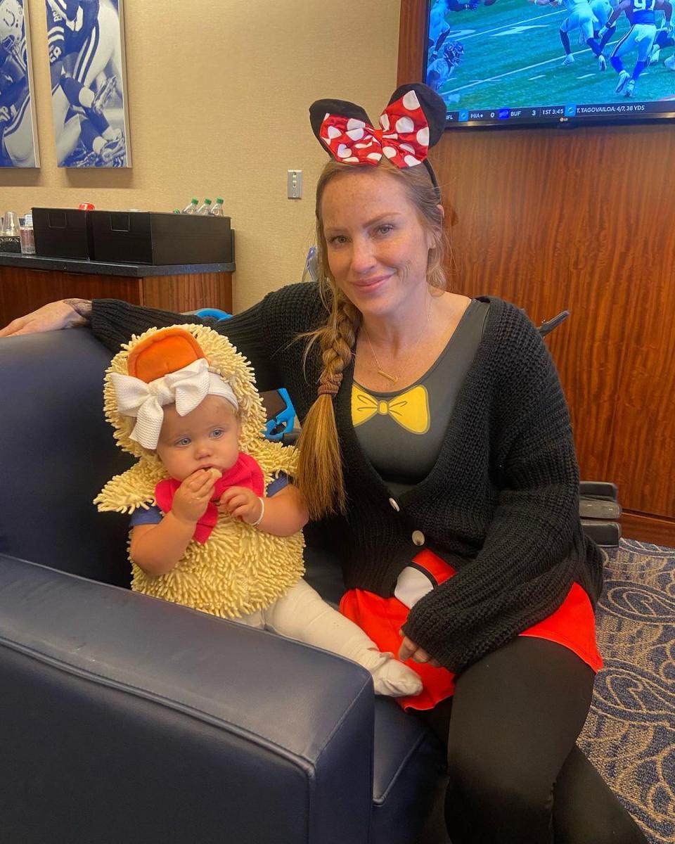 Mina Starsiak Hawk in costume with daughter Charlie