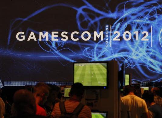 Visitors play computer games during the Gamescom 2012 fair in Cologne August 16, 2012.