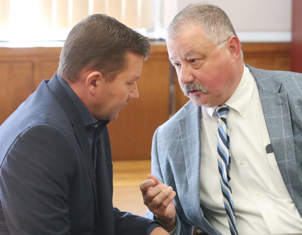 Former state Rep. Bob Young talks with defense attorney John Greven after being found guilty of domestic violence and acquitted of assault by Visiting Judge Edward O'Farrell in Barberton Municipal Court on Thursday.