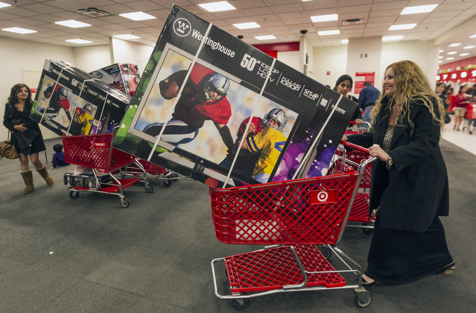 Shopper Lisa Camberos, right, gets a television doorbuster deal at the Target store in Burbank, Calif., on Thursday, Nov. 22, 2012. While stores typically open in the wee hours of the morning on the day after Thanksgiving known as Black Friday, openings have crept earlier and earlier over the past few years. Now, stores from Wal-Mart to Toys R Us are opening their doors on Thanksgiving evening, hoping Americans will be willing to shop soon after they finish their pumpkin pie. (AP Photo/Damian Dovarganes)