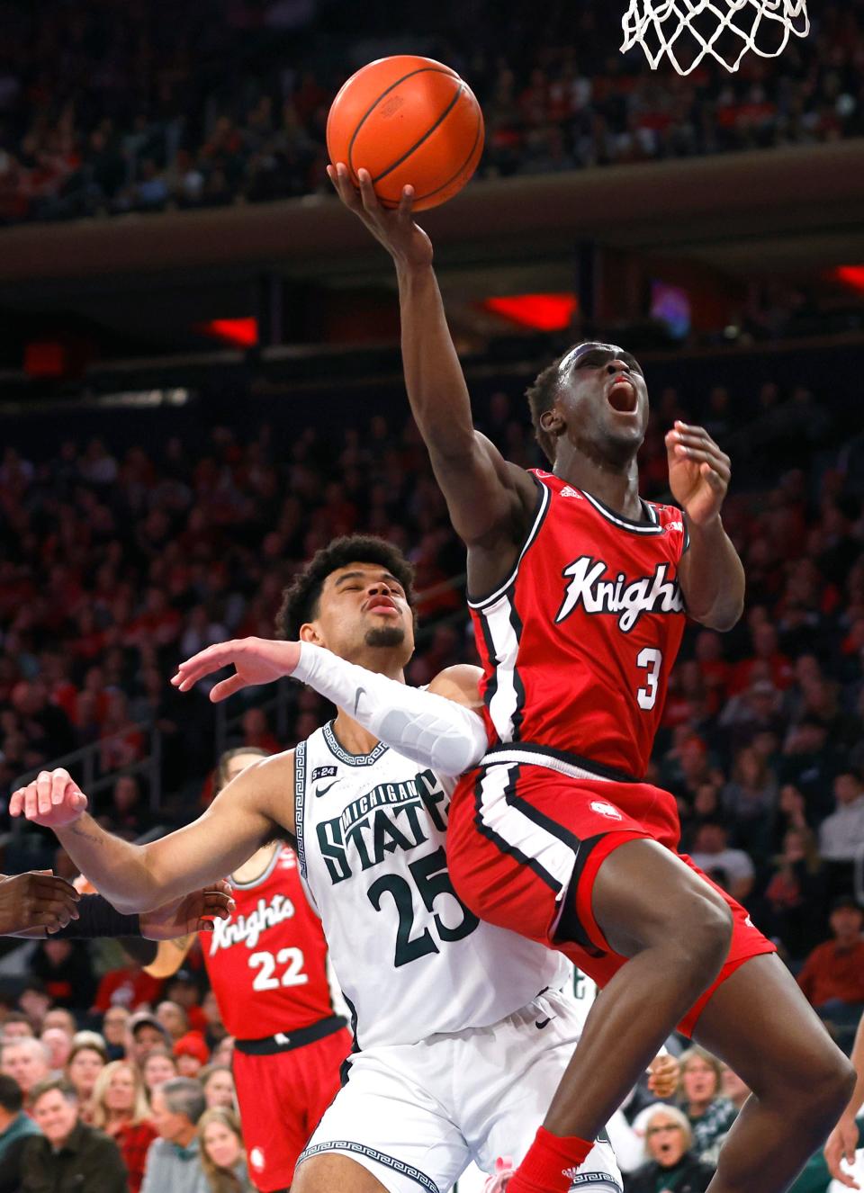 Rutgers forward Mawot Mag (3) drives to the basket against Michigan State forward Malik Hall (25) during the first half of an NCAA college basketball game in New York, Saturday, Feb. 4, 2023. (AP Photo/Noah K. Murray)