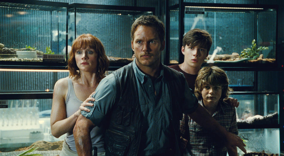 Chris Pratt stands in front of Bryce Dallas Howard, Chris Pratt, Nick RObinson, and Ty Simpkins