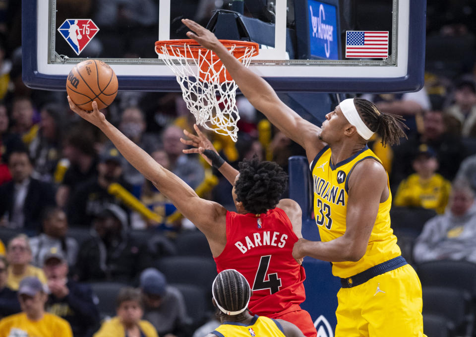 Indiana Pacers center Myles Turner (33) attempts to block a shot by Toronto Raptors forward Scottie Barnes (4) during the second half of an NBA basketball game in Indianapolis, Friday, Nov. 26, 2021. (AP Photo/Doug McSchooler)