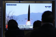 People watch a TV showing a file image of North Korea's missile launch shown during a news program at the Seoul Railway Station in Seoul, South Korea, Thursday, Jan. 20, 2022. Accusing the United States of hostility and threats, North Korea on Thursday said it will consider restarting "all temporally-suspended activities" it had paused during its diplomacy with the Trump administration, in an apparent threat to resume testing of nuclear explosives and long-range missiles. (AP Photo/Ahn Young-joon)