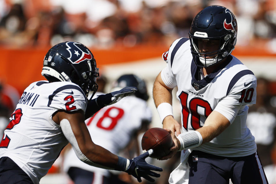 Houston Texans quarterback Davis Mills (10) hands the ball off to running back Mark Ingram (2) during the second half of an NFL football game against the Cleveland Browns, Sunday, Sept. 19, 2021, in Cleveland. (AP Photo/Ron Schwane)