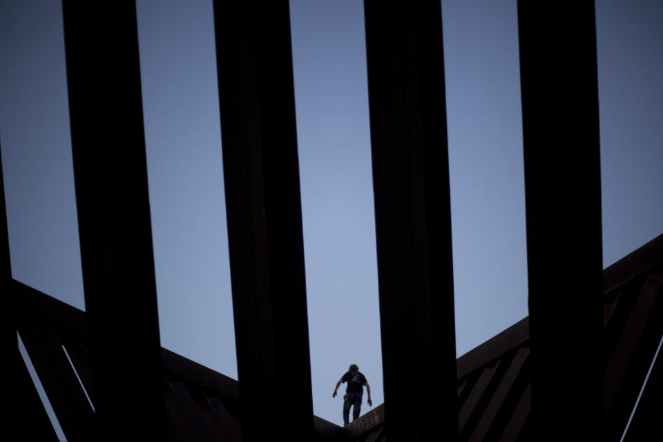 A person climbs on a Holocaust memorial statue in Rabin Square in Tel Aviv, Israel, Sunday, March 24, 2013. (AP Photo/Ariel Schalit)