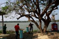 Fishermen stand in front of the Pemex oil port know as Dos Bocas in Paraiso, Tabasco, Mexico April 24, 2018. REUTERS/Carlos Jasso/Files