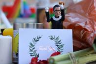 Flowers and tributes are seen as people gather in front of the U.S. Supreme Court following the death of U.S. Supreme Court Justice Ruth Bader Ginsburg, in Washington