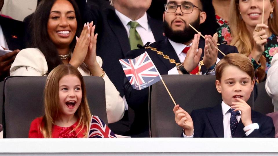 PHOTO: Prince George, right, and Princess Charlotte watch the Platinum Jubilee concert taking place in front of Buckingham Palace, London, June 4, 2022. (Henry Nicholls/Pool via AP)