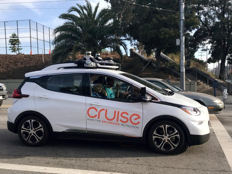 A white car that reads "Cruise, join the driverless revolution."