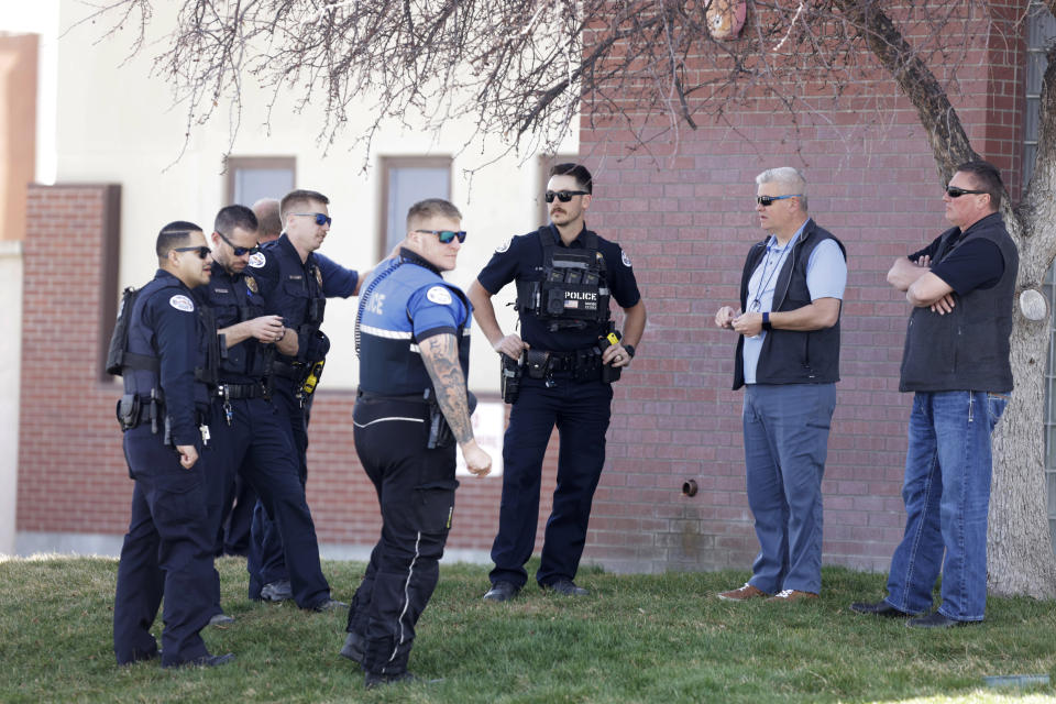 A heavy police presence gathers outside of the Twin Falls Court House while two of the suspects in an attack on corrections officers at a Boise, Idaho, hospital appeared before a judge, Friday March 22, 2024, in Twin Falls, Idaho. (AP Photo/Kyle Green)