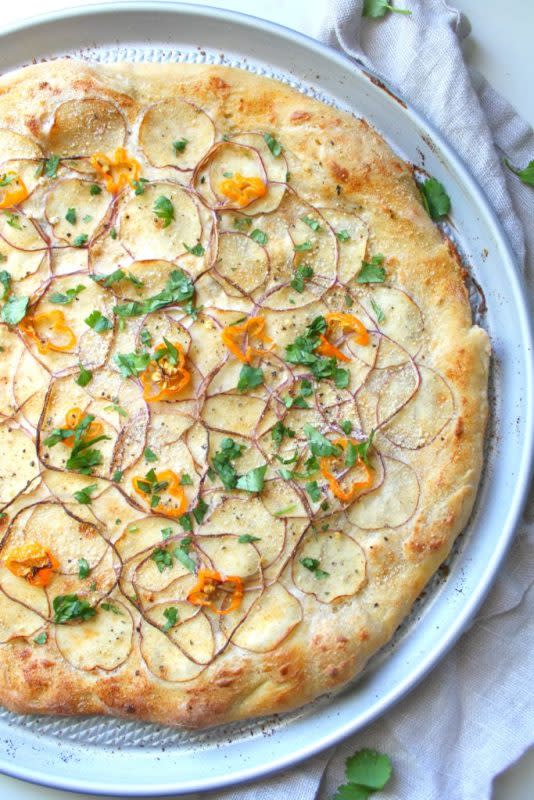 <p>This Savory Vegan</p><p>This vegan potato habanero white pizza is the perfect balance of spice and creaminess. Topped with thin potato slices and red onion.</p><p><strong>Get the recipe: <a href="https://www.thissavoryvegan.com/vegan-potato-habanero-white-pizza/" rel="nofollow noopener" target="_blank" data-ylk="slk:Vegan Potato Habanero White Pizza;elm:context_link;itc:0;sec:content-canvas" class="link rapid-noclick-resp">Vegan Potato Habanero White Pizza</a></strong></p>