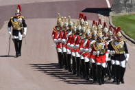 Members of the military during the procession ahead of Britain Prince Philip's funeral at Windsor Castle, Windsor, England, Saturday April 17, 2021. Prince Philip died April 9 at the age of 99 after 73 years of marriage to Britain's Queen Elizabeth II. (Jeremy Selwyn/Pool via AP)