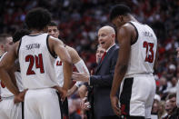 Louisville head coach Chris Mack talks to his players during the second half of an NCAA college basketball game against Syracuse Wednesday, Feb. 19, 2020, in Louisville, Ky. Louisville won 90-66. (AP Photo/Wade Payne)